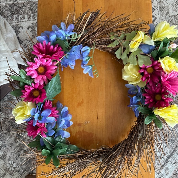 colorful faux flower wreath vibrant pink yellow blue on rustic twig base